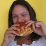 Lady eating a burger