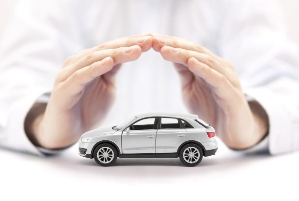 hand protecting a silver car